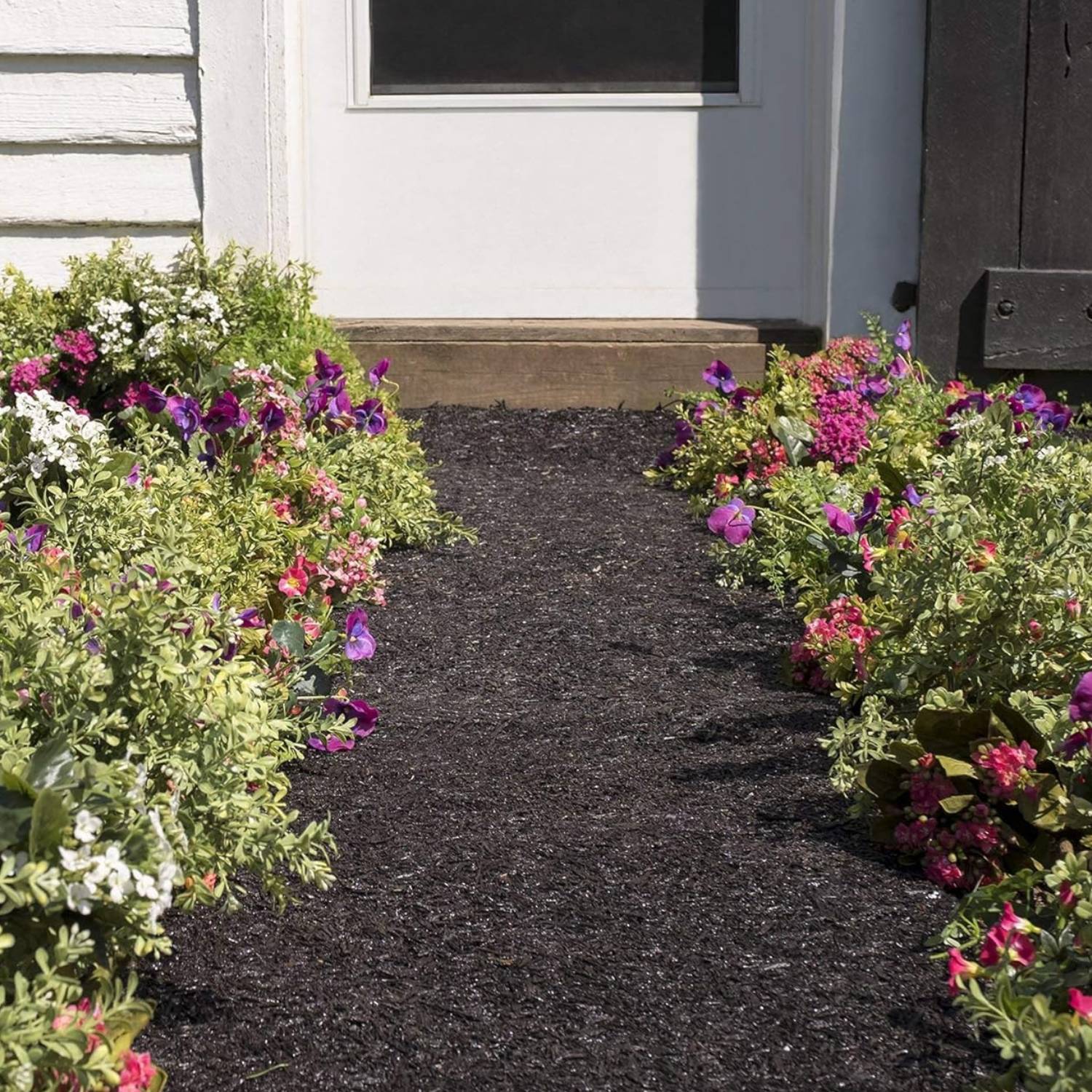 Stone effect bed border holding a planted bed back from the lawn