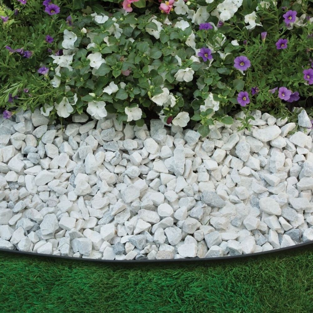 Flexible plastic garden edging kit laid along a curved bed